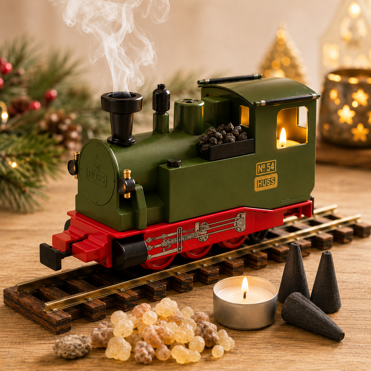 HUSS Incense Train green, locomotive incense burner with smoke rising from the chimney, a glowing tealight, and incense cones on railway tracks displayed on a table with Christmas decor.