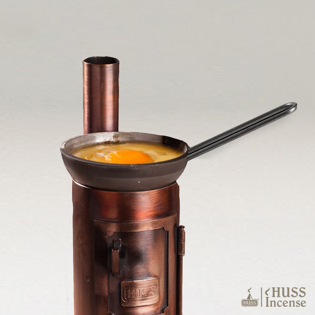 HUSS Incense Steel Pan detail view with cooking egg