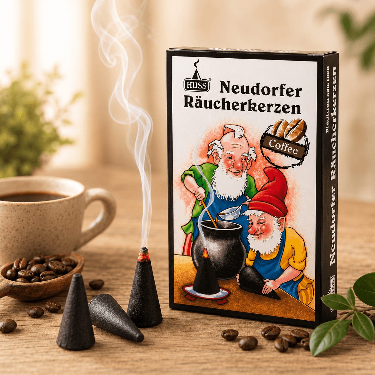 A box of HUSS Incense Coffee cones, together with smoking incense cones, coffee beans, and a coffee cup on a wooden table.