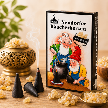 HUSS Incense Cone box Frankincense, three cones with one lit and smoke, some resin laying on a wooden table