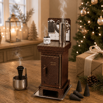 Steaming HUSS Incense cone oven in copper on a table with some incense cones and Christmas deco