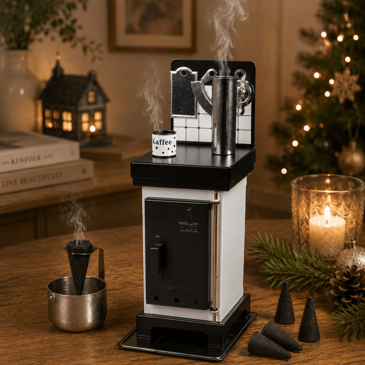 Steaming HUSS Incense cone oven in white/black on a table with some incense cones and Christmas deco