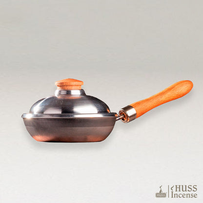 HUS Incens iron pan on a grey background.