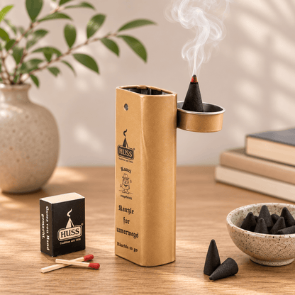 HUSS Incense Karl to go; incense holder in beige with a burning incense cone, matches, and incense cones displayed on a wooden table.