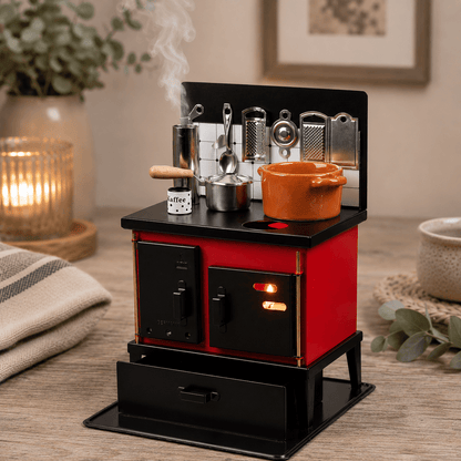 HUSS Incense red and black multi-purpose oven with miniature cookware, kitchen utensils, and rising steam on a wooden table.