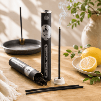 HUSS No. 1 Citrus incense sticks with holder and tube packaging, featuring a burning incense stick releasing gentle smoke beside fresh lemons in a bright summer-inspired setting.