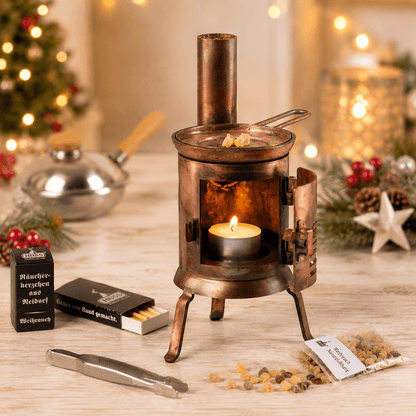 HUSS Incense Table Huss'l a copper oven burner with a lit tealight, natural frankincense resin, and resin accessories displayed in a Christmas scene.