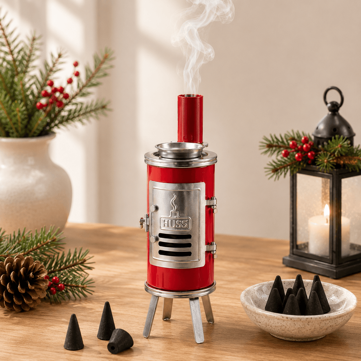 HUSS Incense Glue oven, red with silver accents, smoking chimney, and incense cone holder, displayed on a wooden table with incense cones in a cozy home setting and Christmas decoration.
