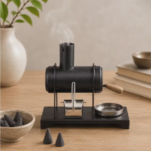 Video of a HUSS Incense small workshop oven with smoke rising from the chimney, incense cones, and metal tray displayed on a wooden table.