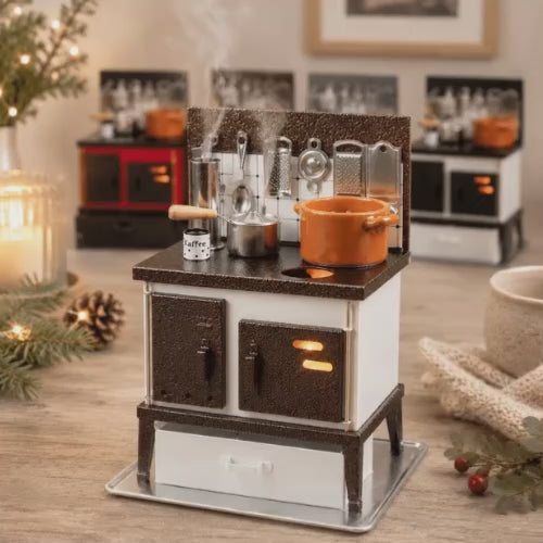 Video of a HUSS Incense white and copper multi-purpose oven with miniature cookware, kitchen utensils, and rising steam on a wooden table with a hand opening the oven's door showing a tealight burning.